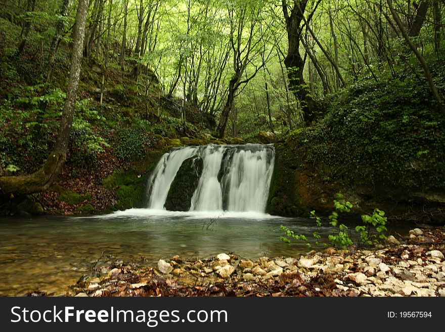 Beautiful river forming small waterfalls in a forest. Beautiful river forming small waterfalls in a forest