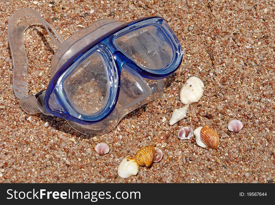 Diving glases, corals and sea shells - all on the sand. Diving glases, corals and sea shells - all on the sand