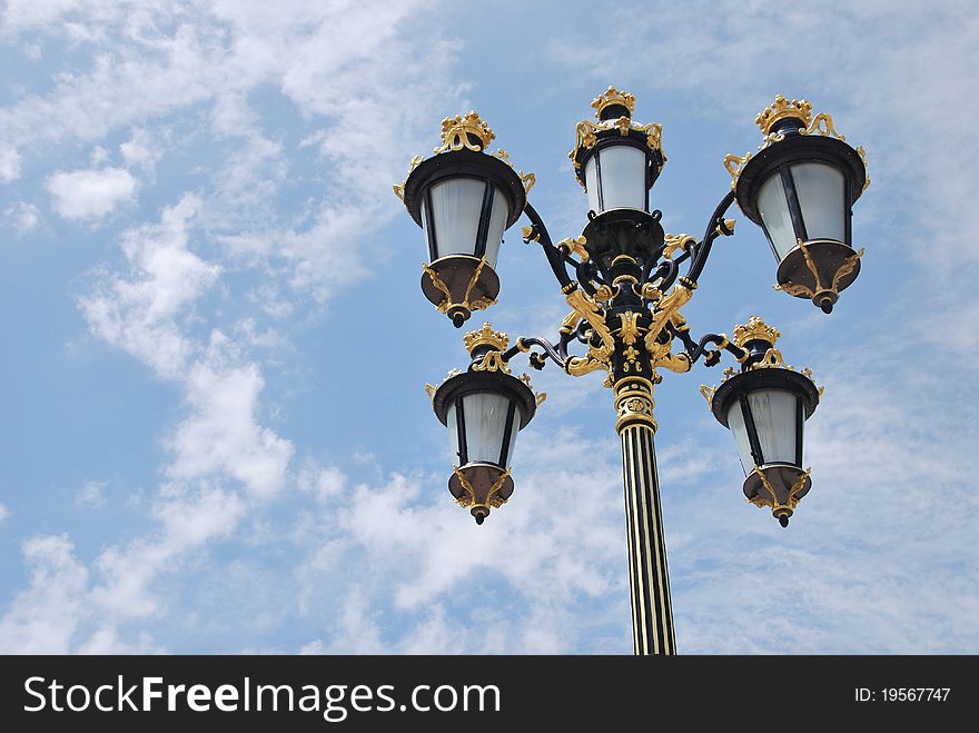 View of a lamppost over a cloudy sky. View of a lamppost over a cloudy sky