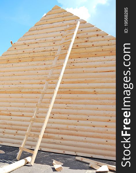 Wall from logs and a wooden ladder. Wall from logs and a wooden ladder