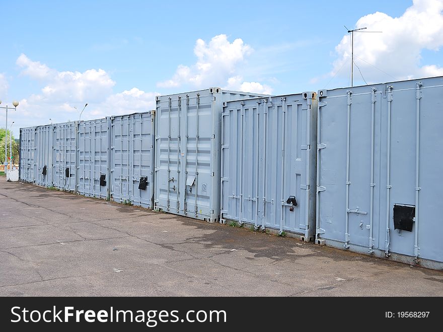 A row of metal containers under the blue sky