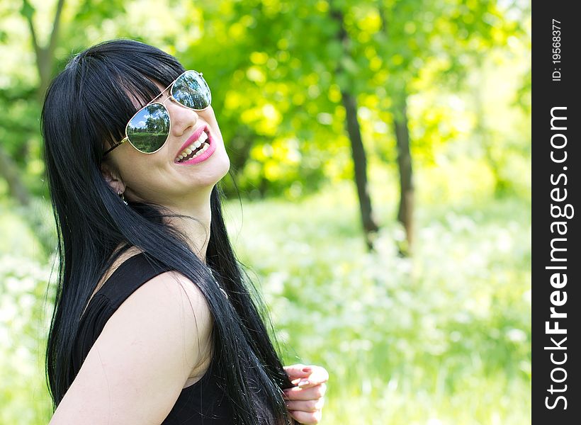 Single young woman wearing sunglasses outdoor. Single young woman wearing sunglasses outdoor