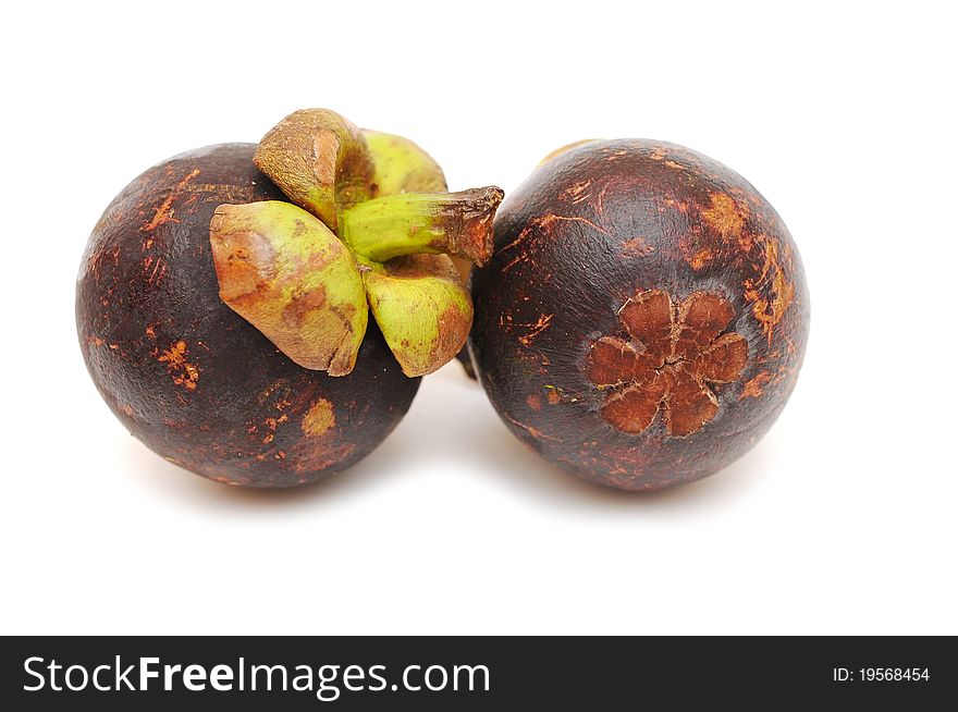 Two mangosteens isolated on white