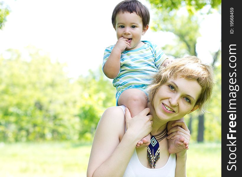 Young mother with little son at the park. Young mother with little son at the park