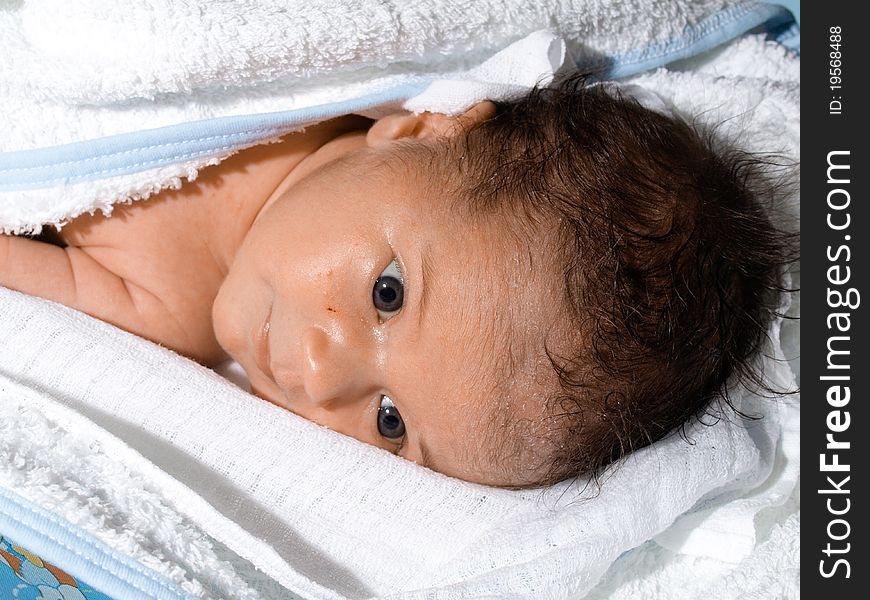 Very little baby born, after warm bath child lies in white towel. Very little baby born, after warm bath child lies in white towel