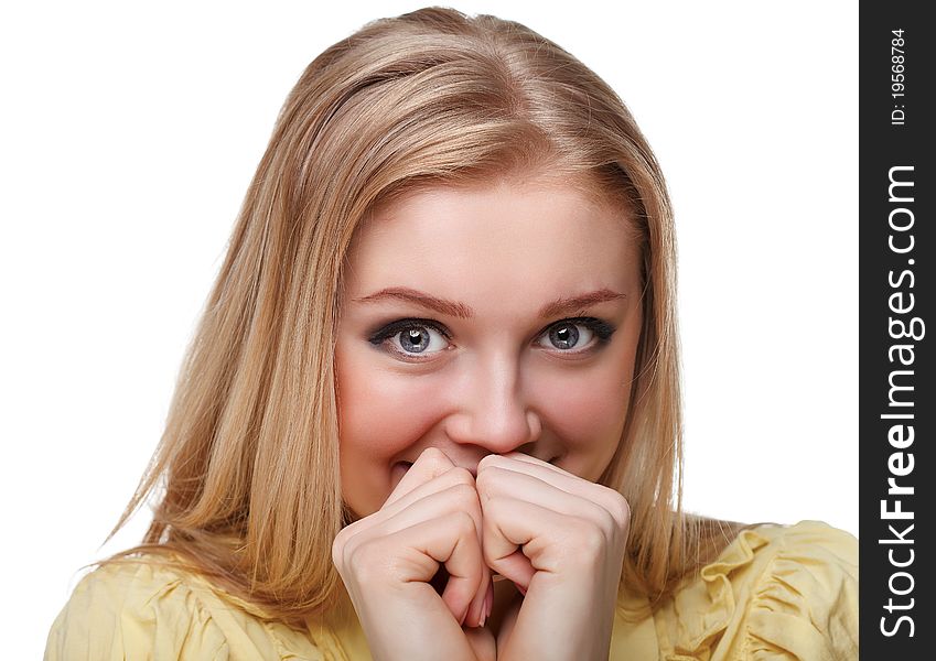 Portrait shot of a beautiful caucasian woman. Holding her face in astonishment.