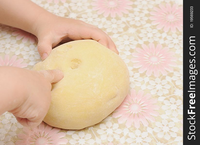 Child's hands kneading dough