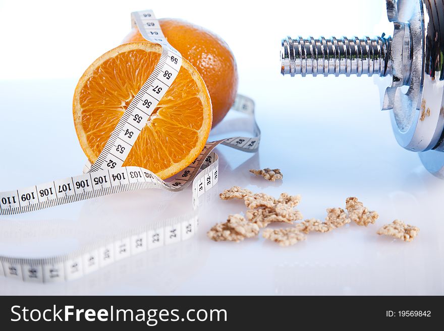 Orange with measuring tape and dumbells. Orange with measuring tape and dumbells