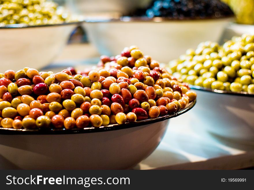 A bowl of green and yellow olives