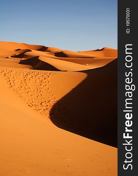 Dunes os Sahara desert and blue sky. Dunes os Sahara desert and blue sky