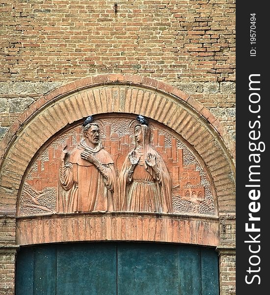 An arch with religious carvings over a door in a cathedral in Siena, Italy. An arch with religious carvings over a door in a cathedral in Siena, Italy