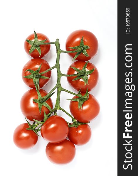 The close-up of a bunch of small red tomatoes