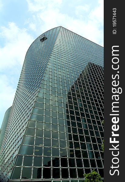 Modern high-rise geometric glass and steel structure commercial building. Modern high-rise geometric glass and steel structure commercial building