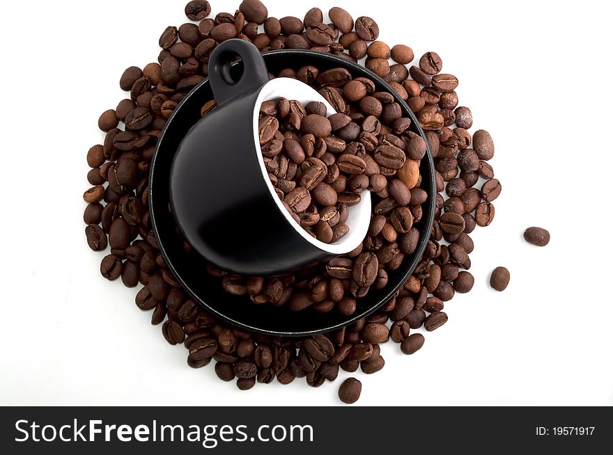 Coffee mug with coffee beans isolated on white
