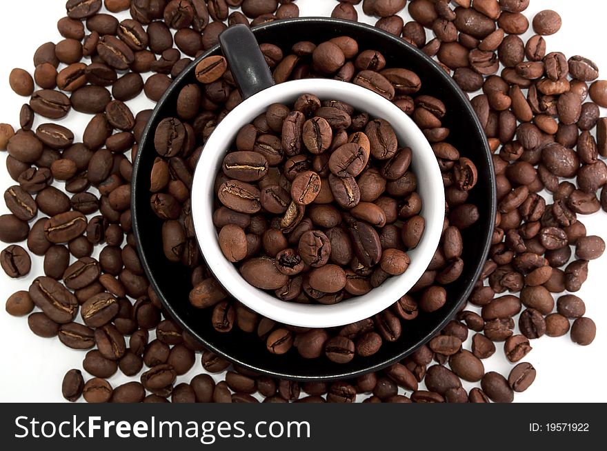 Cup of coffee beans isolated on white