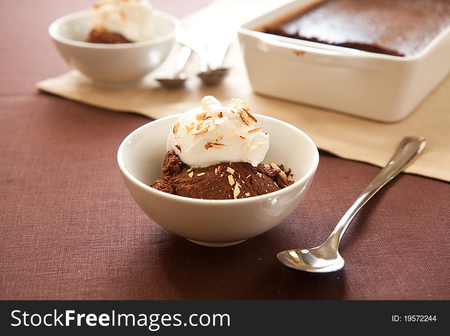 Italian dessert chocolate sformato topped with whipped cream and almonds