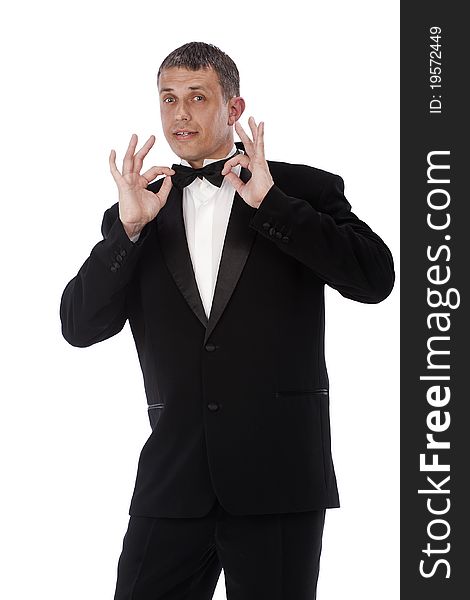 The charming imposing man tries on a new classical tuxedo for solemn ceremony. The charming imposing man tries on a new classical tuxedo for solemn ceremony
