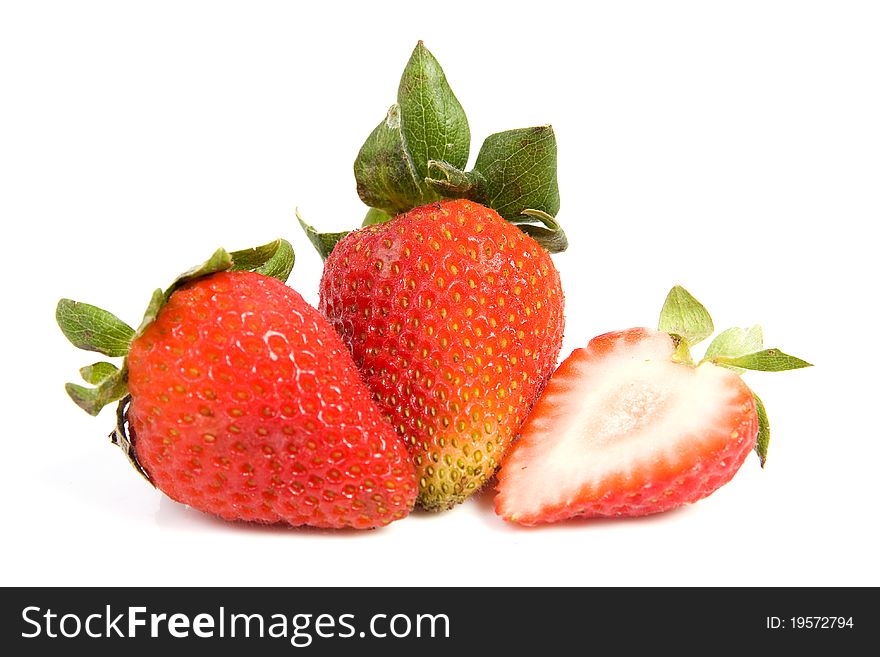 Image of two isolated strawberries, one of them is sliced in half. Image of two isolated strawberries, one of them is sliced in half.