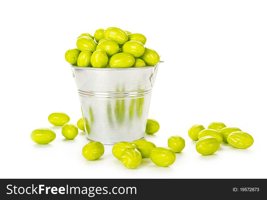 Lots of colorful flowers in a steel bucket. Isolated on white background. Lots of colorful flowers in a steel bucket. Isolated on white background