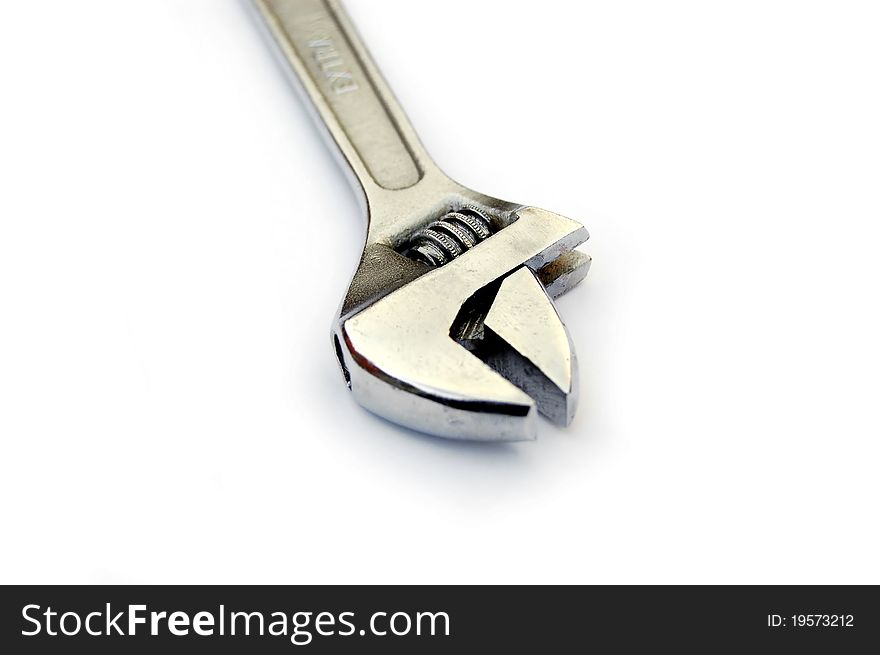 An adjustable wrench against a white background