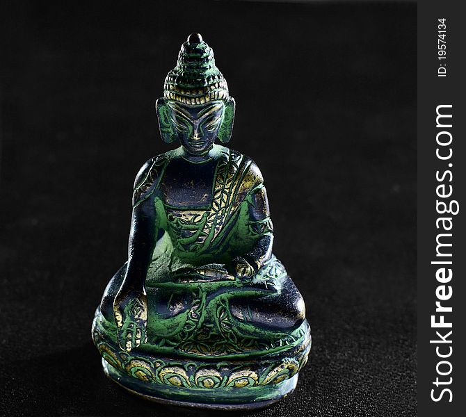 Bronze Buddha statue on black background