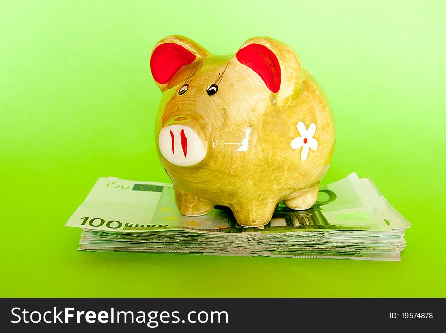 Piggy bank isolated on green