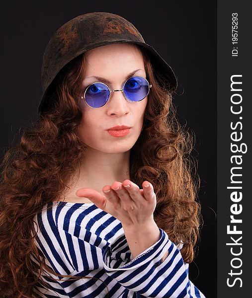 Emotional portrait of a girl in a vest and a military helmet. Emotional portrait of a girl in a vest and a military helmet