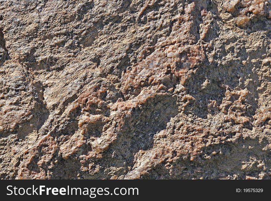 Fragment of natural brown stone surface background texture. Fragment of natural brown stone surface background texture