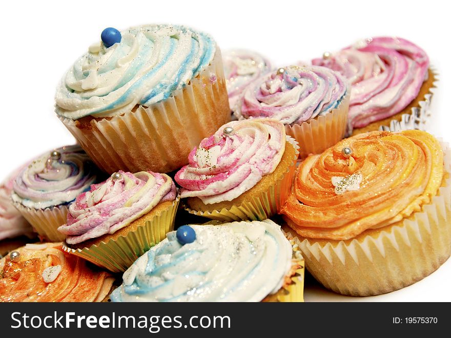 Colorful cupcakes with glitter on a white background