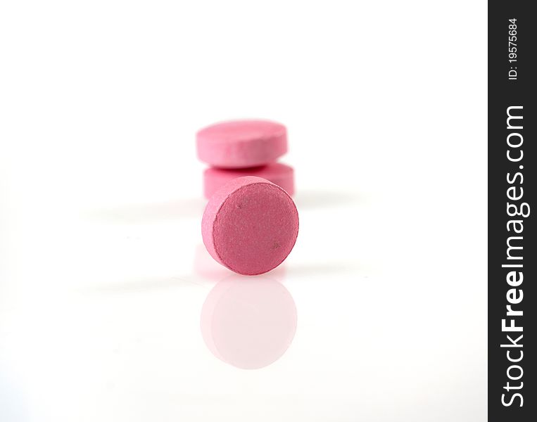 Isolated pink pills on white background