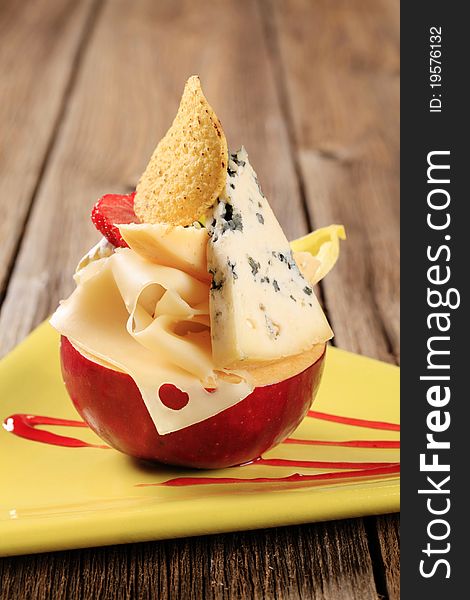 Various types of cheese and red apple. Various types of cheese and red apple