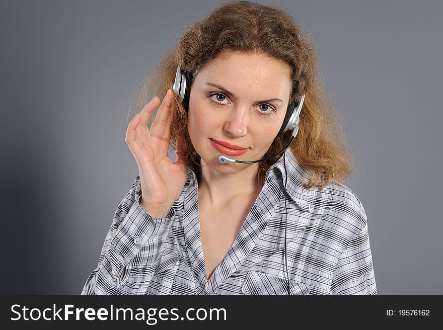 Female customer service representative in headset, on a grey background
