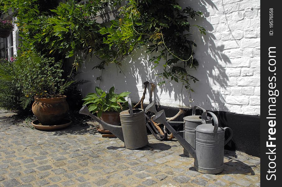 Collection of watering cans in a small country house. Collection of watering cans in a small country house