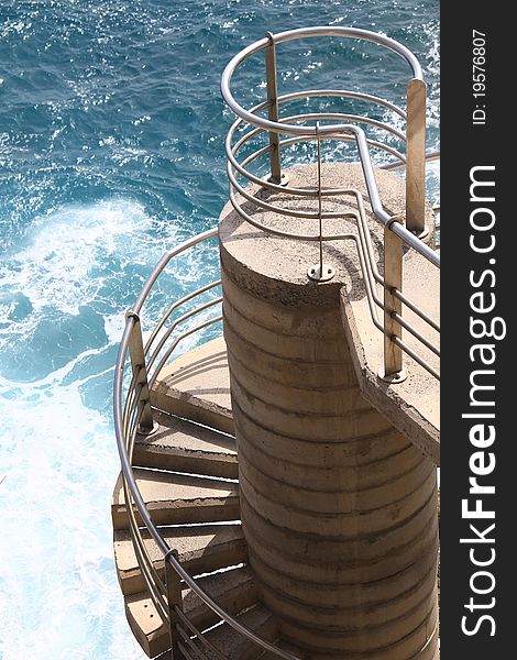 Image of a stairway spiraling to the top overlooking the sea