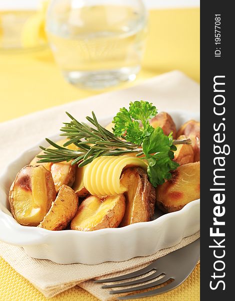 Halves of roasted potatoes in a casserole dish