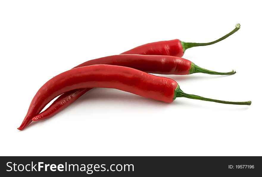 Three chili peppers isolated on white background