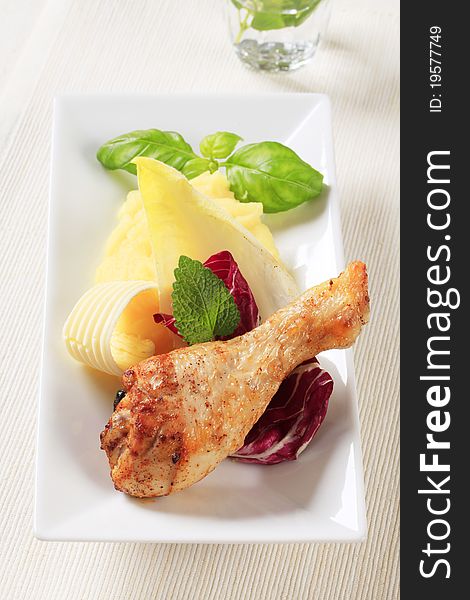 Roasted chicken drumstick served with mashed potato. Roasted chicken drumstick served with mashed potato