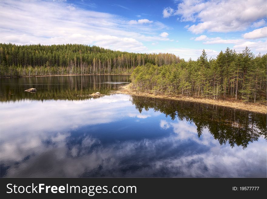 A beautiful lake surrounded by woods, in Finland