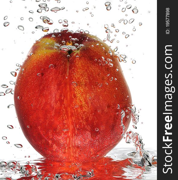 A macro shot of juicy nectarine under water with bubbles rising. A macro shot of juicy nectarine under water with bubbles rising.