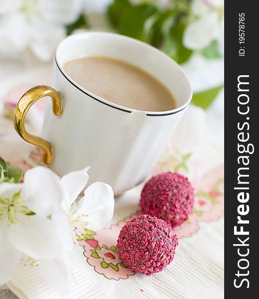 White coffee in old coffee cup with pink candy