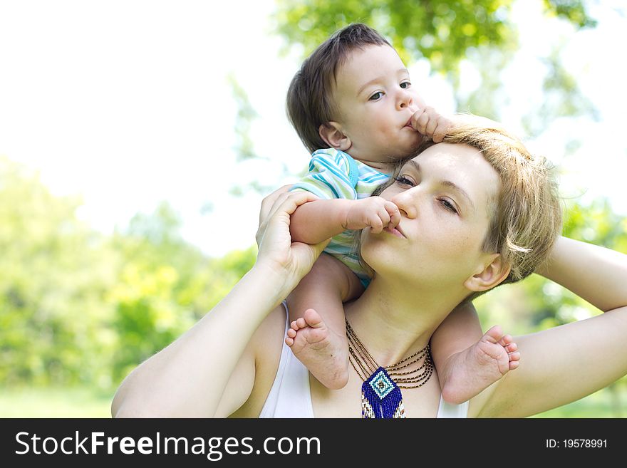 Young mother with little son at the park. Young mother with little son at the park