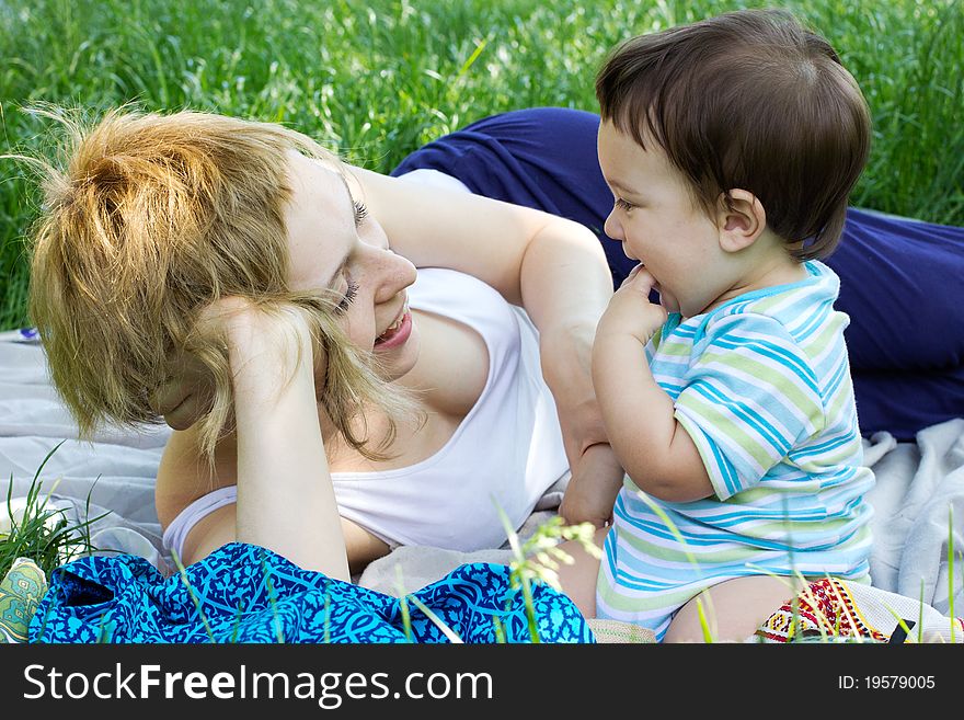 Young mother with little son at the park. Young mother with little son at the park