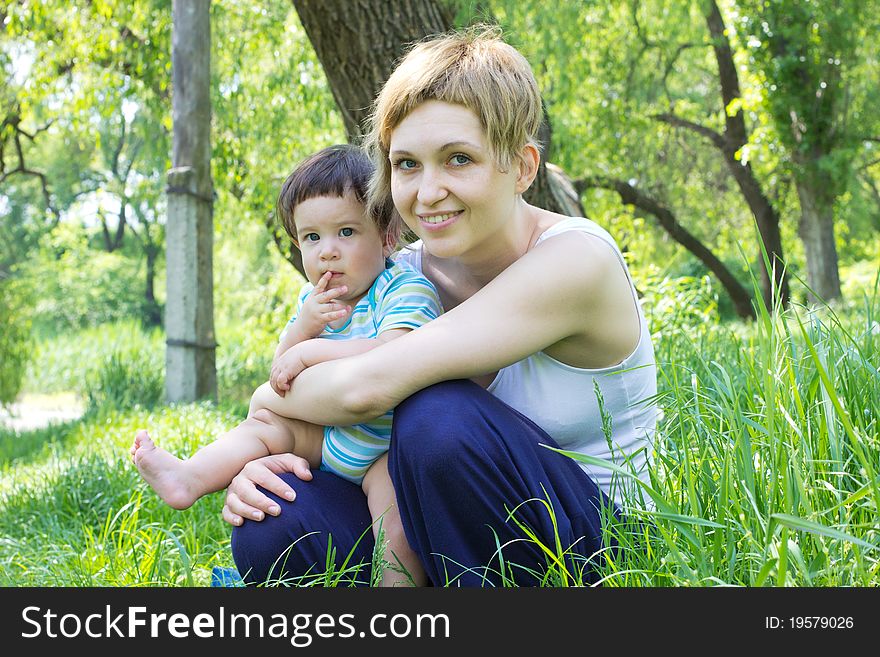 Young mother with little son at the park. Young mother with little son at the park