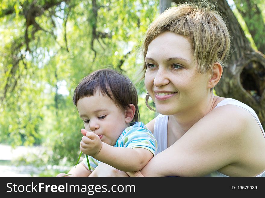 Young mother with little son at the park. Young mother with little son at the park