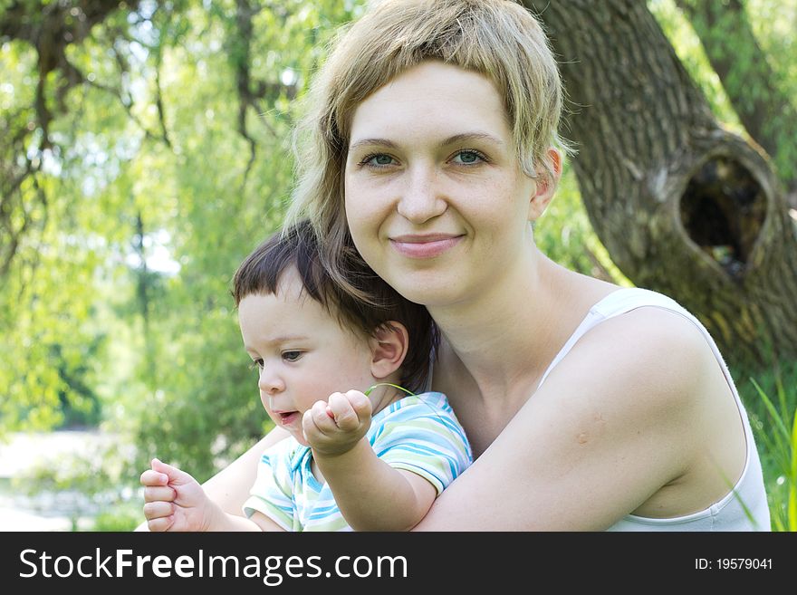 Young mother with little son at the park. Young mother with little son at the park