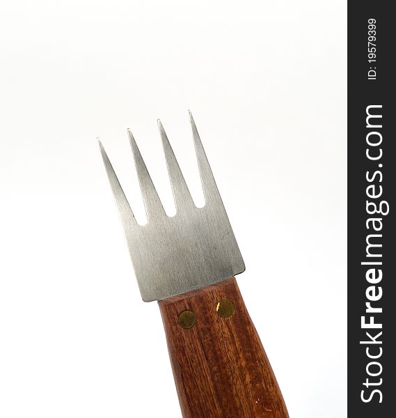 A steel fork with wooden handle on white background. A steel fork with wooden handle on white background