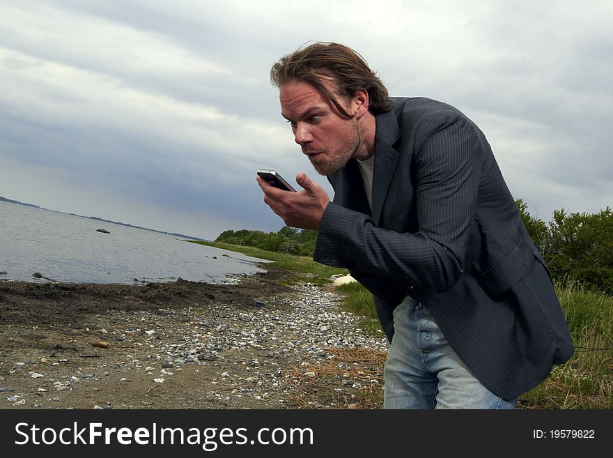 Man with phone on beach