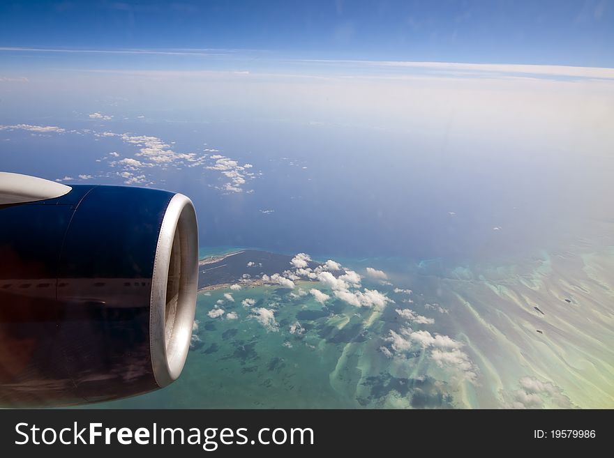 Flying over a blue ocean and tropical islands. Flying over a blue ocean and tropical islands