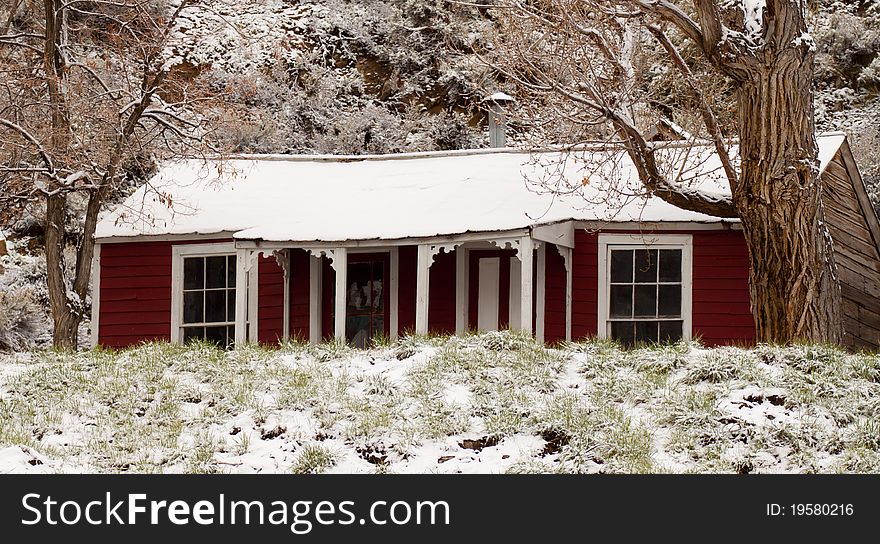 A beautiful photo of an old red house on a snowy day. A beautiful photo of an old red house on a snowy day.