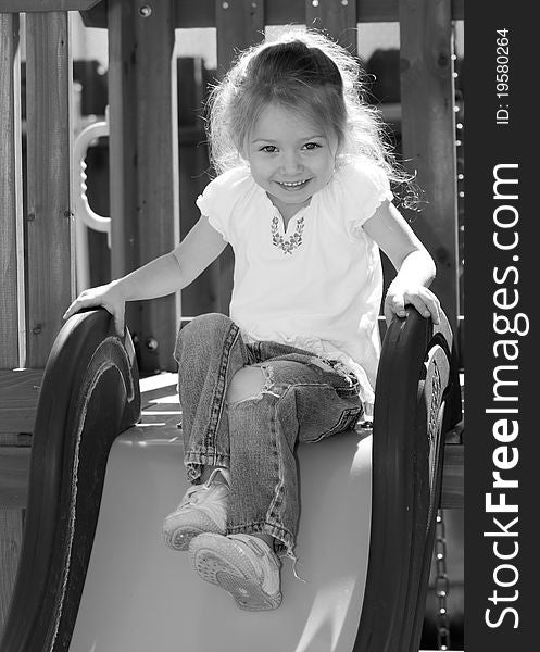 A photograph of an adorable child playing on some playground equipment. A photograph of an adorable child playing on some playground equipment.
